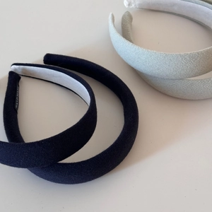 Close-up of knit fabric texture and handmade label on padded headband for women