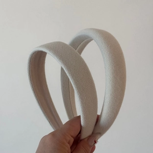 Detail of sponge-filled cream hairbands with textured knit fabric for high crown hair styling