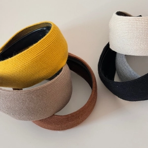 Detail of multi-color knitted headbands showing waffle texture and elastic fabric material