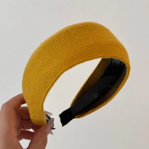 Detailed view of yellow knit headband showing fine texture and inner non-slip teeth