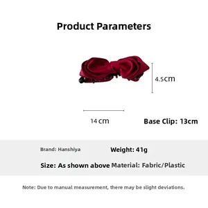 Detail of red satin bow banana clip with dimensions 14x4.5cm and non-slip inner teeth