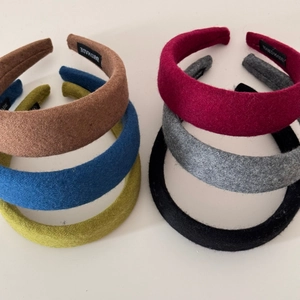 Detail view of handmade thick wool headbands in six autumn colors with textured fabric