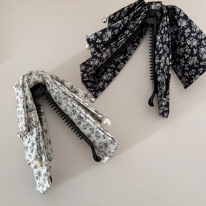 Detail of floral fabric banana clips with elegant pearl and silver bead decorations