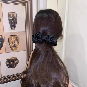 Elegant French black satin bow banana hair clip worn by a model for a chic look