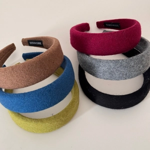 Thick padded wool sponge headbands in various colors with handmade label detail