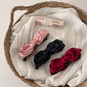 French satin bow banana clips in pink, black, and burgundy with non-slip teeth detail