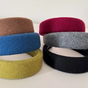 Detailed view of six colorful thick wool knitted headbands with sponge padded design