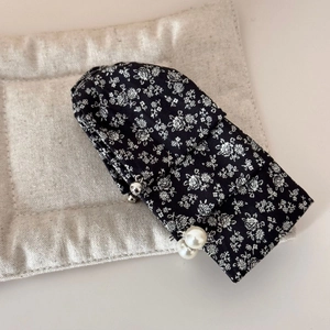 Close-up of French floral fabric banana hair clip with elegant pearl pendant details