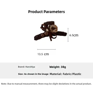 Detail view of brown velvet bow hair claw with knitted flower and 13.5cm size mark
