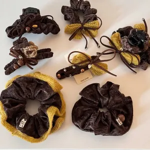 Velvet bow hair claw clip and scrunchie set in warm dark coffee and bright yellow tones