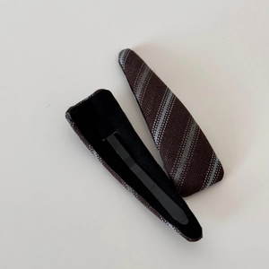 Detailed macro view of vintage brown twill fabric hair clips with non-slip velvet lining