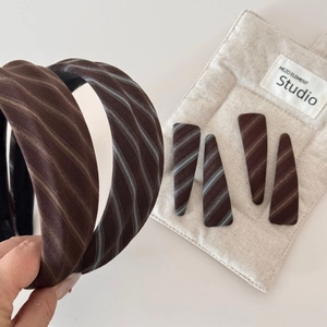 Close-up of retro brown striped fabric headbands and matching triangle hair clips