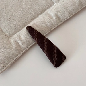 Macro detail of brown striped fabric texture on a wide-edge padded headband