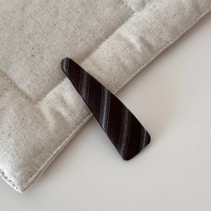 Detail view of coffee twill fabric texture on a wide headband for women fashion