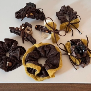 Detailed set of brown velvet hair accessories featuring a bow and beaded accents