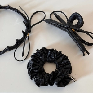 Three-piece black faux leather hair accessory set with ribbon bow clip and scrunchie