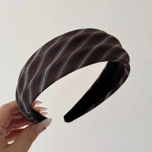 Detailed texture of brown twill headband with blue and white stripes and anti-slip lining