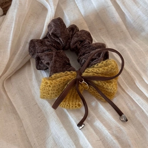 Detailed shot of a velvet bow hair clip with a gold Princess charm and crystal pendant
