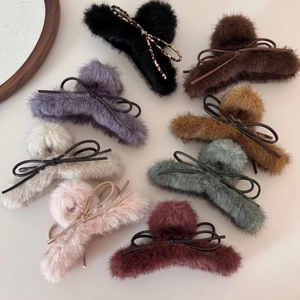 Vue détaillée des pinces à cheveux en fausse fourrure pelucheuse avec nœuds élégants