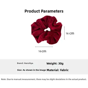 Detailed view of large burgundy velvet scrunchie showing 16cm diameter and soft texture