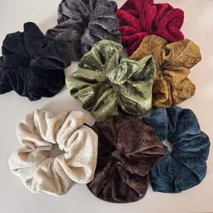 Set of 8 large velvet hair scrunchies in various solid colors on white background