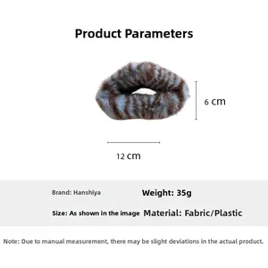 Detail showing plush cloud hair claw clip dimensions of 12cm by 6cm in brown and white
