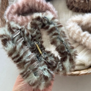 Close-up of plush leopard print hair claw clip showing soft fur texture and metal spring