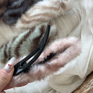 Detailed macro view of soft faux fur duckbill hair clips with inner teeth for secure grip