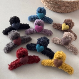 Detailed set of nine colorful wool felt heart claw clips in warm autumn winter plush textures