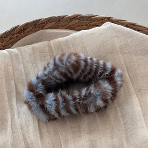 Detailed view of the soft brown and grey striped plush texture of the cloud hair claw clip