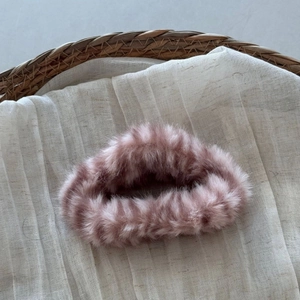 Detailed texture of dusty rose faux fur cloud hair claw clip for thick hair styling