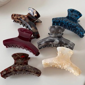 Detail showing six assorted colors of acetic acid hair claws with strong springs
