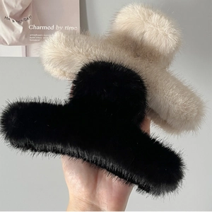 Vue détaillée des pinces à cheveux en fausse fourrure pelucheuse noir et blanc cassé