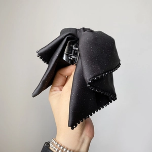 Elegant large black glitter bow hair claw clip with beaded edges for women's hairstyle