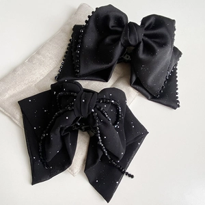 Elegant black beaded bow hair clips set with satin ribbon and sparkling tassel details