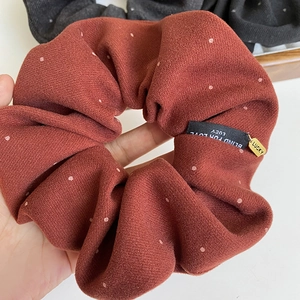 Vintage red fabric scrunchie with white polka dots and lucky gold metal charm