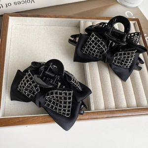Elegant black bow hair claw clip with silver rhinestone grid pattern for women