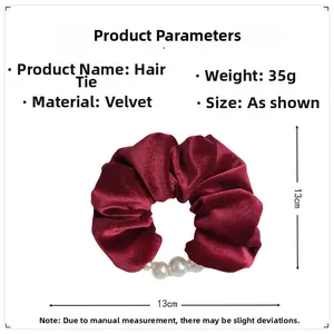 Detailed view of the 13cm burgundy velvet scrunchie with elegant pearl decoration