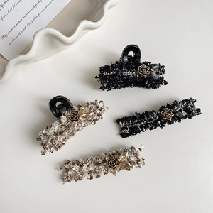 Detail of elegant tweed hair clips set with gold flower and bead embellishments
