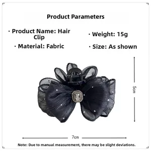 Detail view of black mesh bow hair claw clip with crystal center and dimensions 7x5cm