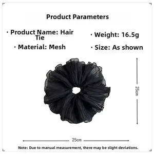 Detail view of oversized black mesh scrunchie with pleated texture and 25cm size dimensions