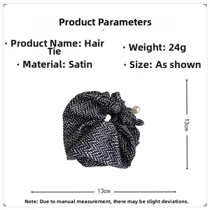Detail view of satin polka dot scrunchie with pearl charm measuring 13cm and 24g