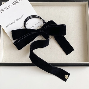 French style black velvet bow hair tie with long ribbons and a gold emblem detail
