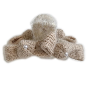 Beige knitted bow hair claw clip with plush trim and faux pearls for a sweet look