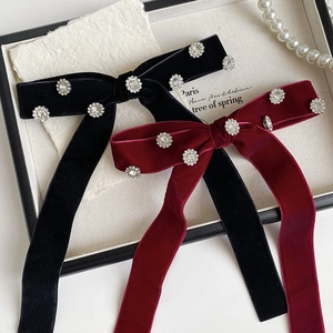 Elegant velvet bow hair clip with rhinestone accents and long ribbons in black and burgundy