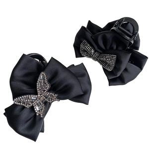 Elegant black satin hair claws with rhinestone butterfly and bow designs in a set