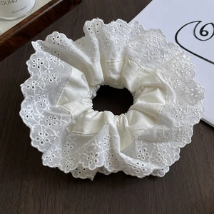 Close-up of double-layer lace scrunchie with intricate embroidery and pleated texture