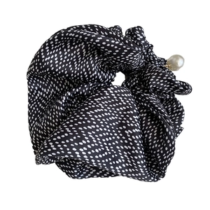 Polka dot satin scrunchie in black with elegant white pearl charm and soft pleated fabric