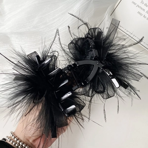 Elegant black feather hair claw clip with sheer mesh layers and vintage style charm