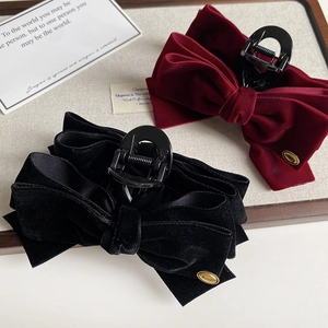 Luxurious velvet bow hair claws in black and burgundy with gold metal wings tag